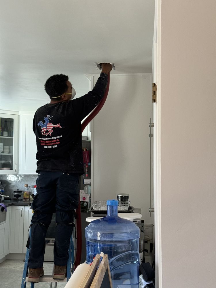 Diego Utor servicing a ceiling vent in a Brentwood home